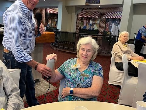 Member Joan tries equipment demonstrated by May 2025 guest Scott Bennett from Niagara Therapy Australia