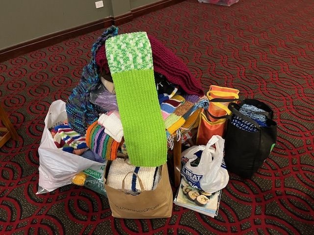 Knitted scarves and beanies donated to the Mission to Seafarers in November 2025